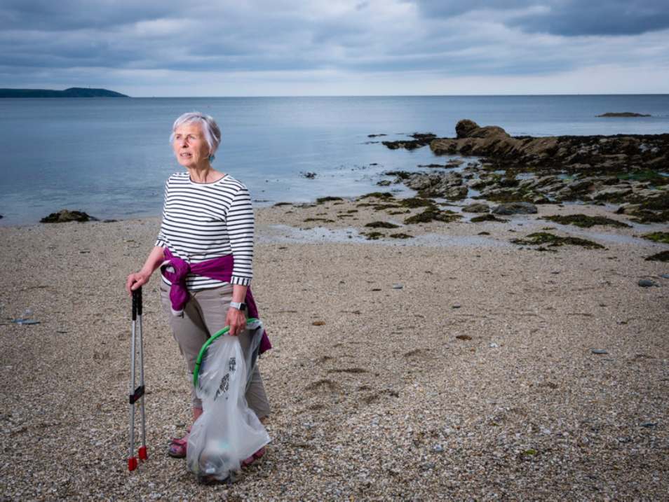 Action Nan on beach with litter picker and recycling bag.jpg