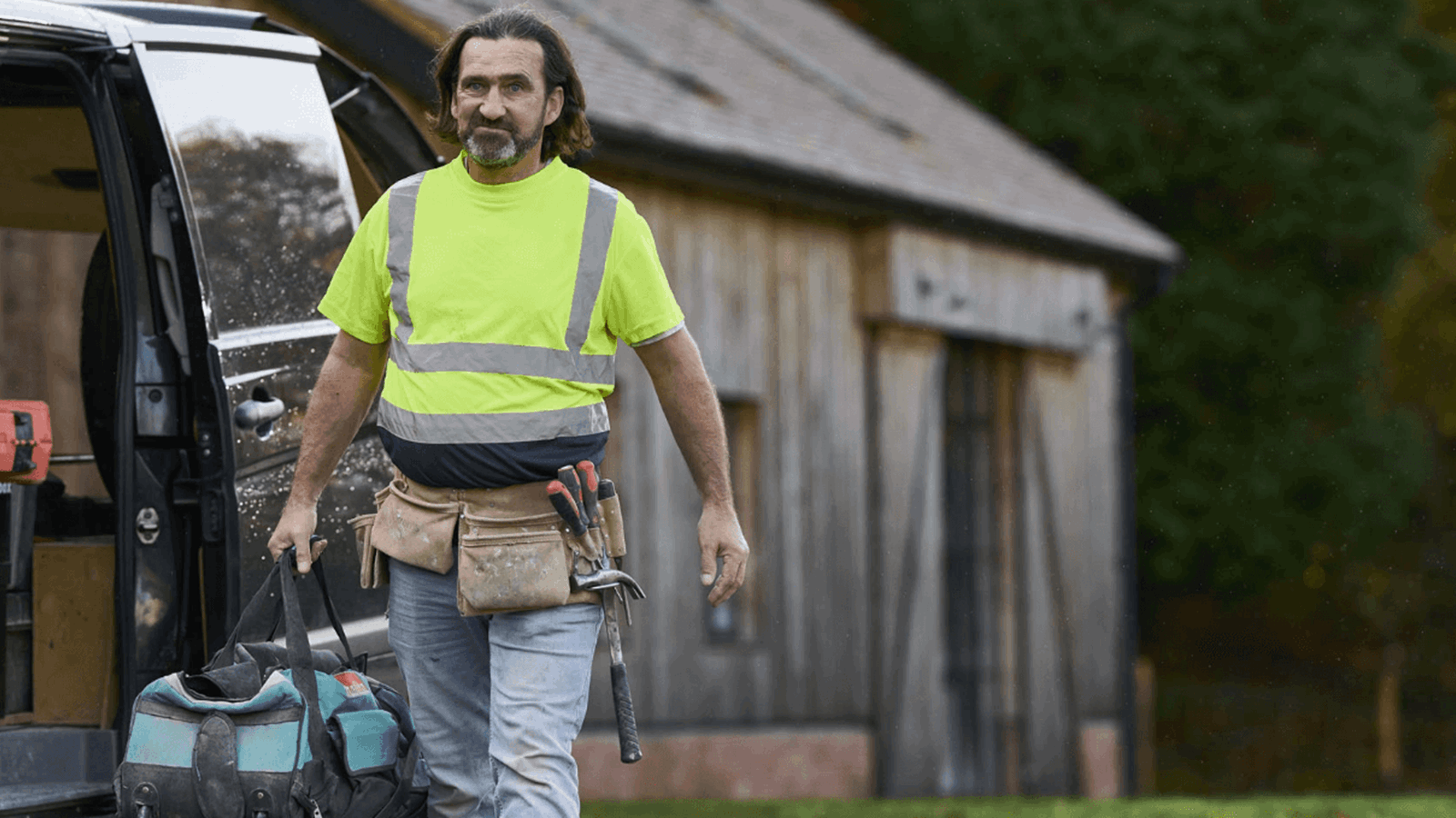 AXA customer Steve the tradesman walking with his tool bag