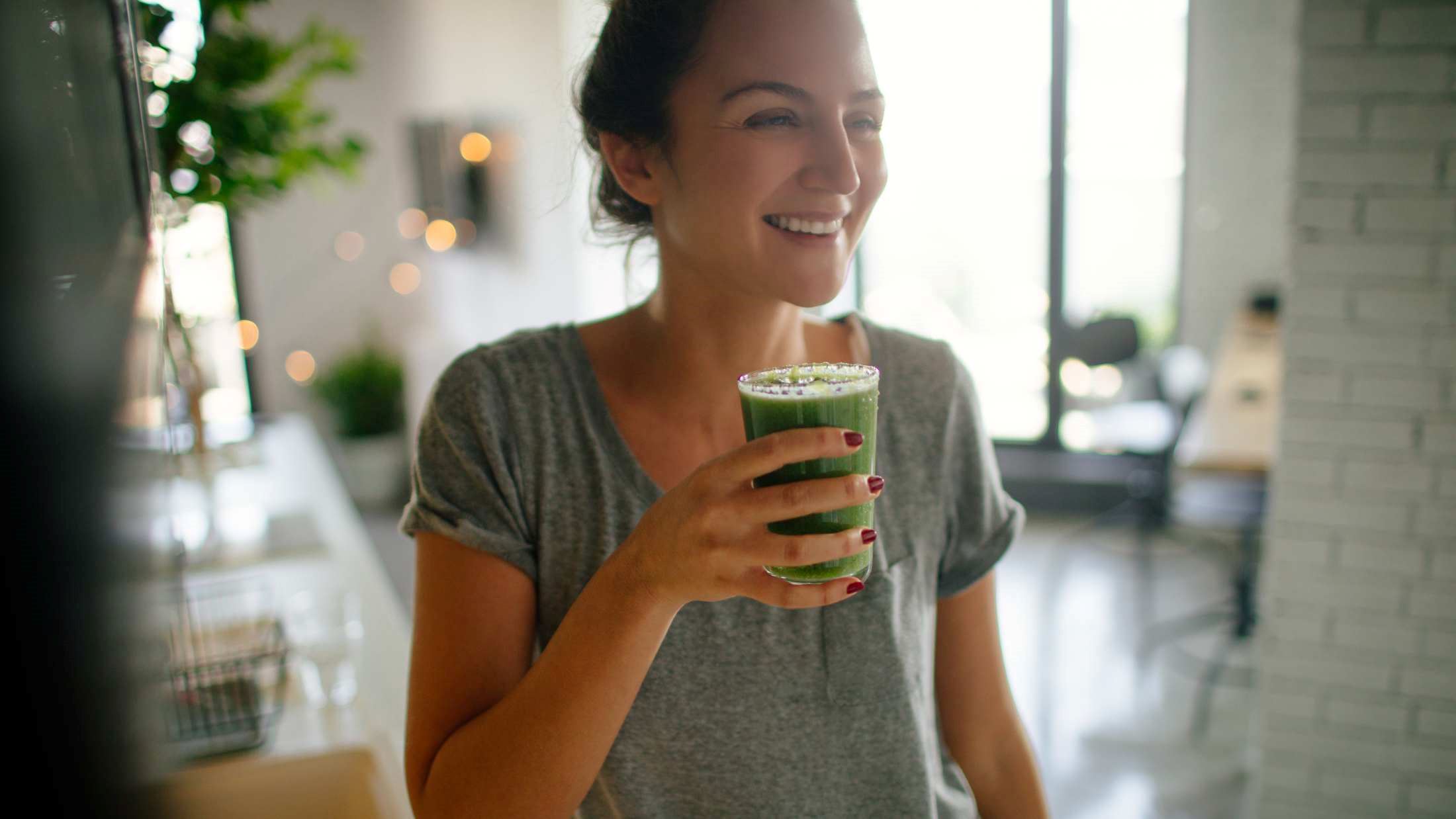 Young smiling woman having healthy breakfast in the morning