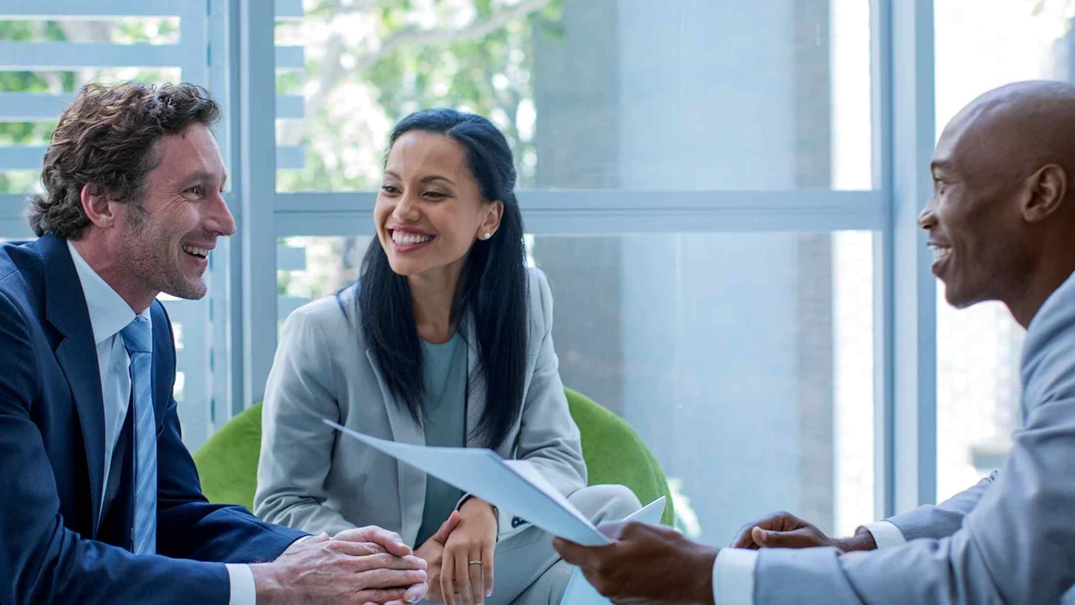 Three business professionals discussing a policy