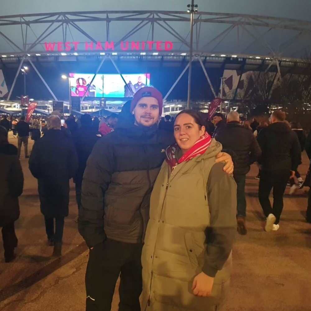 AXA competiton winner for December 2024 Leah stood outside of the Olympic Stadium ahead of the West Ham versus Liverpool Football Club fixture