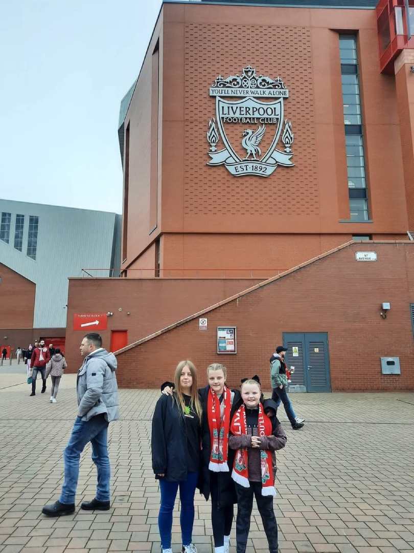 AXA competition winner for October 2024 Shelley stood outside of Anfield ahead of the Liverpool Football Club Women's fixtures against Man City game