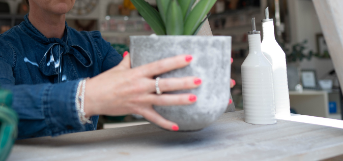 woman moving plant pot